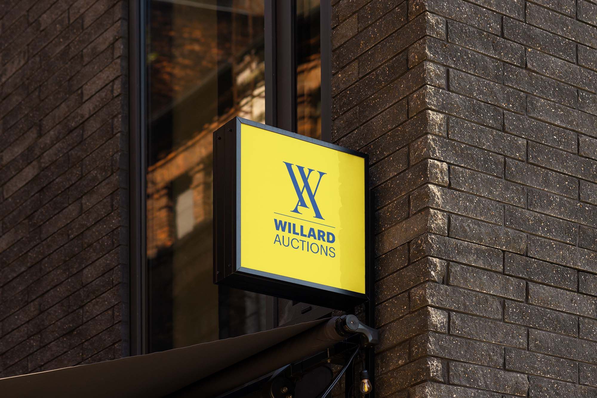 Willard Auctions Logo on Building Sign